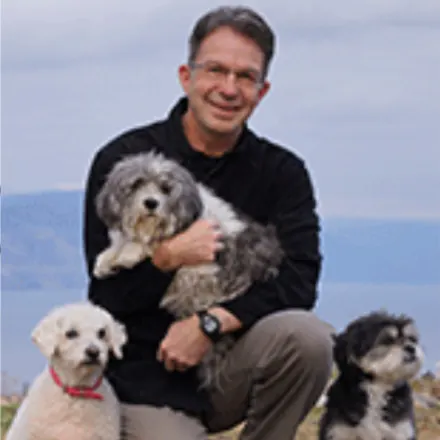 Dr. Kopp with three dogs outside